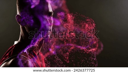 Image of red particles over african american male basketball player. sport and competition concept, digitally generated image.