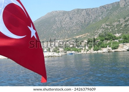 Turkish flag flying from the stern of a sailboat near Turkish coast