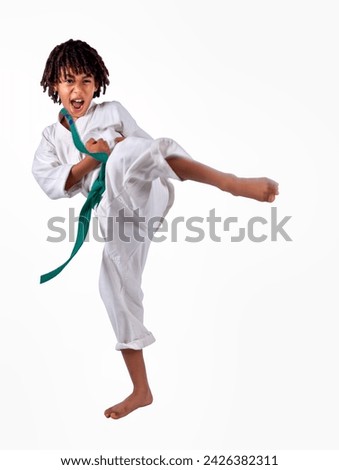 african american boy in karate suit training, uniform karate gi , keikogi or dogi, suit is white, hairstyle with braids, dreadlocks, isolated on white background Royalty-Free Stock Photo #2426382311
