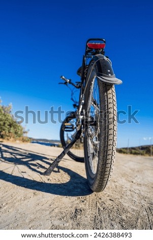 Close up of an electric dirt bike tire against clear blue sky in summer