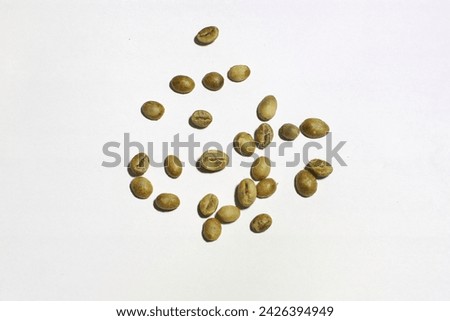 unroasted green coffee beans on a white background
