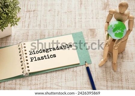 There is notebook with the word Biodegradable Plastics. It is as an eye-catching image. Royalty-Free Stock Photo #2426395869