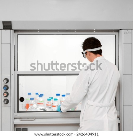 Fume hood. Chemical and biological laboratory. Ventilation equipment for experiments. lab fume cupboards. Scientist working in a fume cupboard in laboratory research. Royalty-Free Stock Photo #2426404911