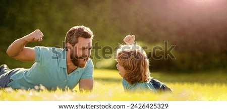Banner of father and son in summer park outdoor. parent relax with little child boy on grass. glad dad with kid on summer day.
