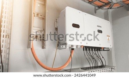 Close up the  inverter unit for solar panel on the wall. Technology of solar energy with shiny light. Royalty-Free Stock Photo #2426441049