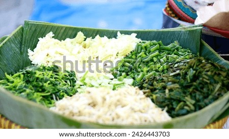 Boiled vegetables to make pecel. Cabbage, bean sprouts, long beans, and spinach. Pecel is a salad of lightly-blanched vegetables, doused in a spicy-sweet peanut gravy. Royalty-Free Stock Photo #2426443703