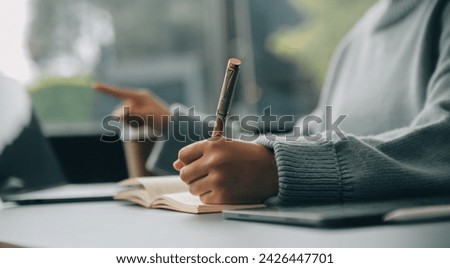 Confident female interpreter translate document from foreign language to english use pc app make notes in paper copy. Professional young woman editor correct errors mistakes in printed article text Royalty-Free Stock Photo #2426447701