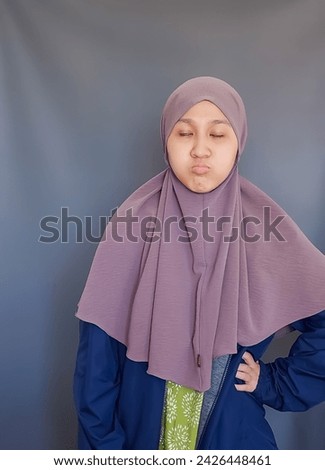 Random pose of Asian girl wearing brown veil on grey background