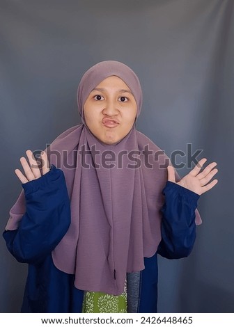 Random pose of Asian girl wearing brown veil on grey background