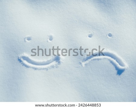 Emoji, face and drawing in snow or outdoor on ground in winter for communication or feedback. Writing, sign and smiley in ice on field in nature with frozen background and written sketch review