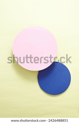 A pastel-toned light green backdrop of pink and blue circle pedestal ,a view of the top, a decorative podium with a flat line. An empty platform for display cosmetic products, food and props