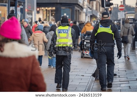 Police in hi-visibility jackets policing crowd control at a UK event Royalty-Free Stock Photo #2426513159