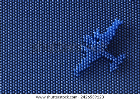 Volumetric silhouette of a two-engine airplane on a blue abstract background of many small spherical mosaic parts. Symbolic of tourism, air travel, vacation or relocation. Photo. Close-up
