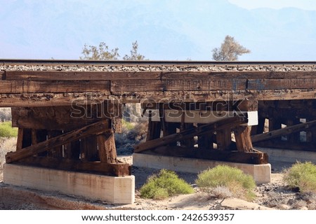 Old fashioned wood timber train trestle in the desert
