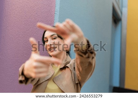woman gesturing with fingers framing