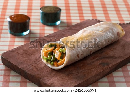 Vegetable Indian Rolls are filled with a tasty concoction of carrots, potatoes, pepper and peas cooked in a blend of spices. horizontal top view from above Royalty-Free Stock Photo #2426556991