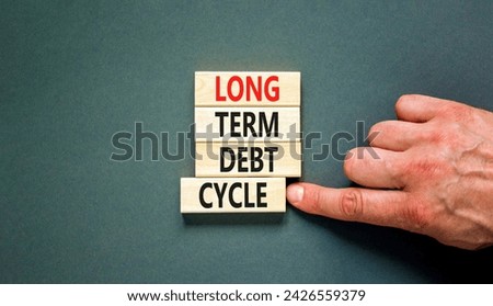 Long term debt cycle symbol. Concept words Long term debt cycle on beautiful wooden block. Beautiful grey table grey background. Businessman hand. Business Long term debt cycle concept. Copy space.