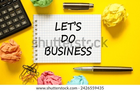 let is do business symbol. Concept words let is do business on beautiful white note. Beautiful yellow background. Black pen. Colored paper. Calculator. let is do business concept. Copy space.