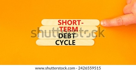 Short-term debt cycle symbol. Concept words Short-term debt cycle on wooden stick. Beautiful orange table orange background. Businessman hand. Business Short-term debt cycle concept. Copy space.