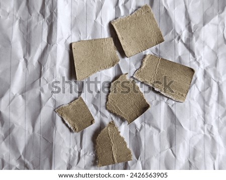 pieces of brown paper on white paper