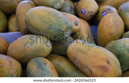 papaya isolated lying on the table with other papaya