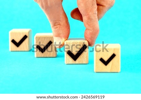 Checklist concept, Check mark on wooden blocks, blue background with copy space.Customer service evaluation, agree, approval concept Royalty-Free Stock Photo #2426569119