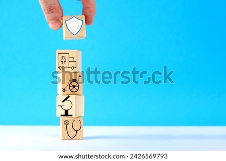 Hand puts wooden cube  with healthcare medical icons. Medical insurance concept. Financing medicine, Price of medical care concept.