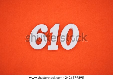 Orange felt is the background. The numbers 610 are made from white painted wood.