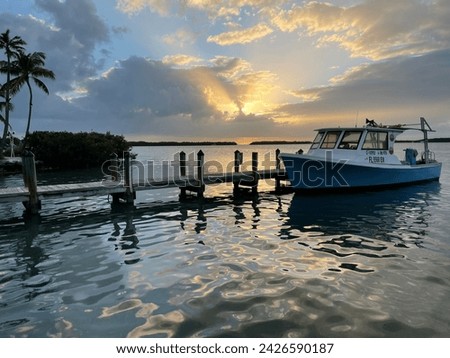 Sunset pictures in Islamorada, Florida, in March.  Beautiful sunset with old boat in the background to capture essence of the area. 