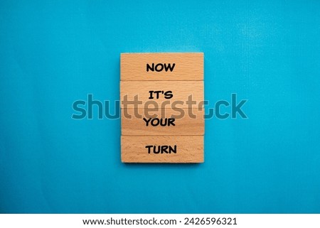 Now it's your turn words written on wooden blocks with blue background. Conceptual business symbol. Copy space.