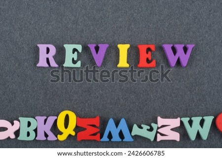 REVENUE word on black board background composed from colorful abc alphabet block wooden letters, copy space for ad text. Learning english concept