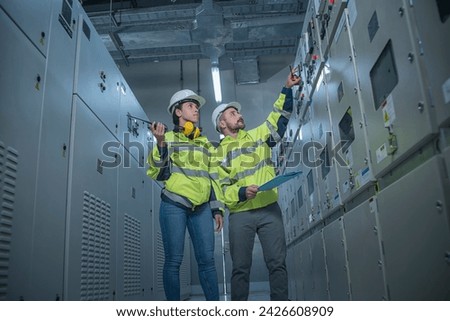 engineer working on the checking status switch gear electrical energy distribution substation Royalty-Free Stock Photo #2426608909
