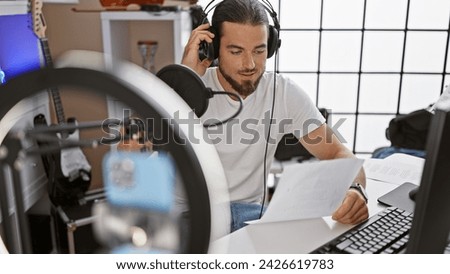 Young hispanic man reporter recording video speaking on radio show at radio studio