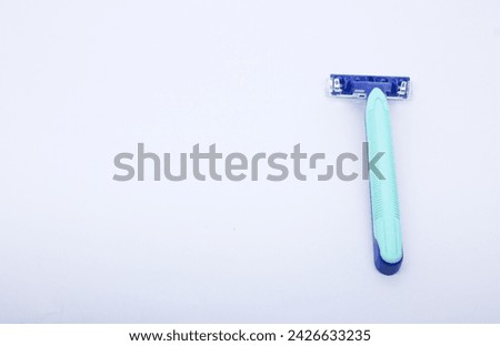 Blue shaving razor isolated on white background