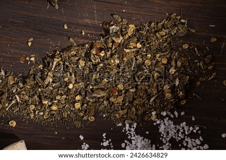 Spicy vegetable spices scattered on a wooden background