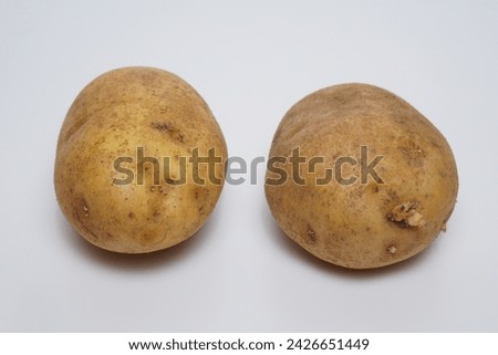 Ripe potatoes with flat lay on white background