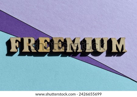 Freemium, a business model that offers both free and extra cost services, word in wooden alphabet letters isolated as banner headline