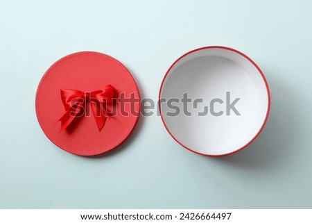 Open gift box on colored background

