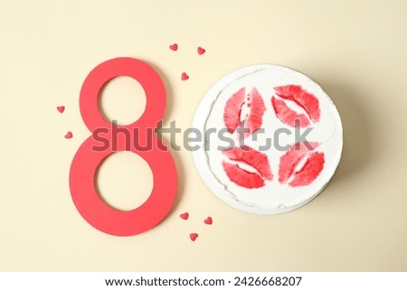 Number 8 and colorful cake decorated with red lips on a colored background