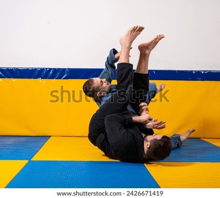Young girls and boys practice Brazilian jiu jitsu in the gym