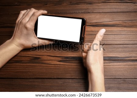 phone with hands addiction on a wooden background