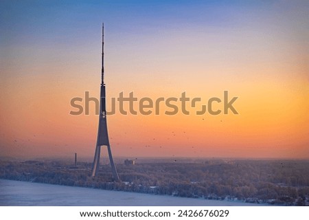 Riga Radio and TV Tower in Riga, Latvia during colourful winter sunset.