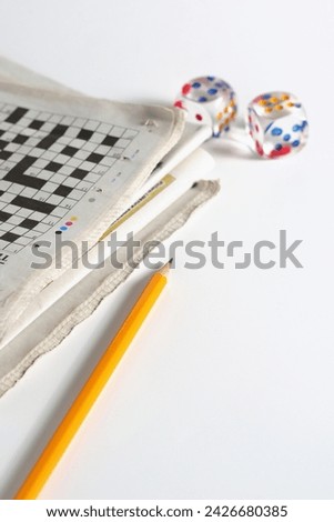 Newspaper, pencil and transparent dice on a white background Royalty-Free Stock Photo #2426680385
