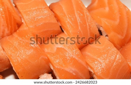Beautiful close-up photo of sushi with salmon. Delicious Japanese food photo in high quality. Stock photo of sushi.