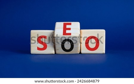 SEO vs SOO symbol. Wooden cubes with words SOO and SEO. Beautiful deep blue background. SEO vs SOO and business concept. Copy space