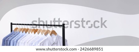 Dry-cleaning service. Different clothes hanging on rack against white background, space for text. Banner design