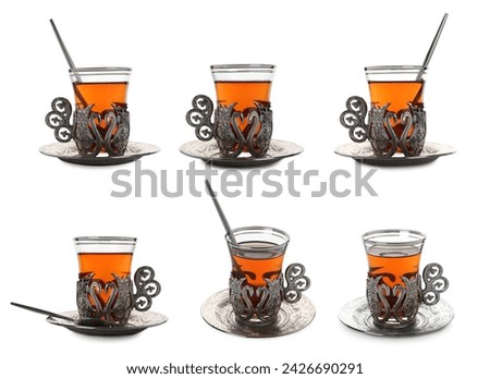 Glasses of traditional Turkish tea in vintage holders isolated on white, set