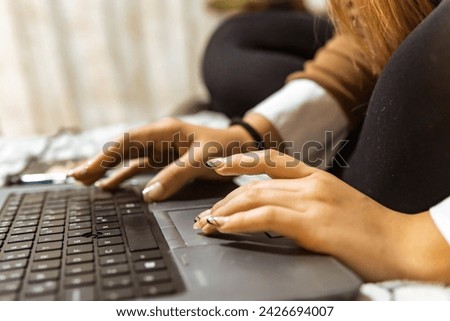 woman working on a computer. Woman using technology. Latina woman hands working. laptop and cell phone.