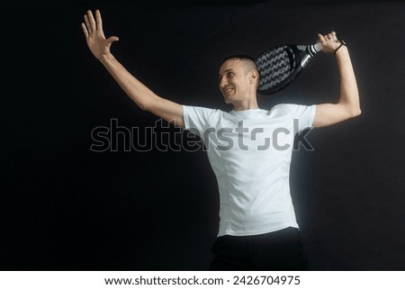 Padel Tennis Player with Racket in Hand. Paddle tennis, on a black background. 