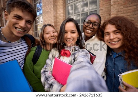 Selfie of a Group of student happy multiracial friends having fun outdoors at university campus. Diverse cheerful joyful young people looking at camera and smiling and laughing together